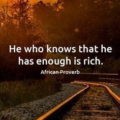 a train track with the words he who knows that he has enough is rich african prove