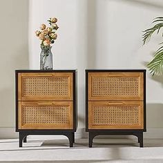 two side tables with flowers in a vase on top and one standing next to each other