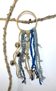 a piece of driftwood with beads and chains hanging from it