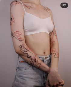 a woman with tattoos on her arm and chest