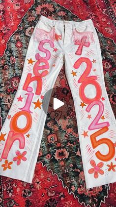 a pair of white pants with the word sale written on it and stars in pink