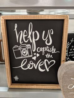 a chalkboard sign that says help us capture the love