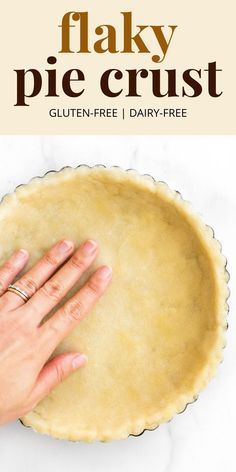 a pie crust is being held by a woman's hand with the text flaky pie crust gluten - free / dairy - free