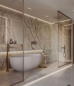 an elegant bathroom with marble walls and flooring, along with a freestanding bathtub