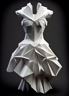 an origami dress made out of white paper on a black background with light coming from the back