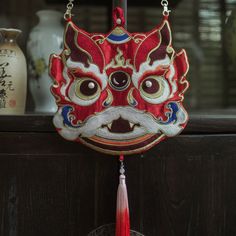 a red mask hanging from the side of a shelf