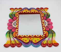 a colorful mirror is sitting on the wall