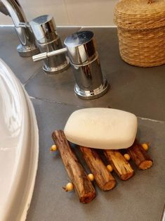 a soap bar sitting on top of a counter next to wooden sticks and other items