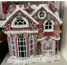 a gingerbread house is decorated with candy canes