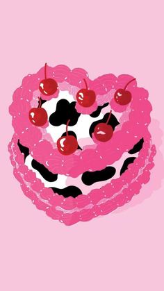 a pink cake with cherries and black spots on it's top is shown