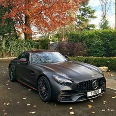 the mercedes amg gt is parked in front of some trees