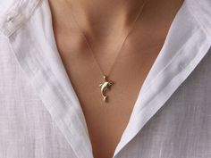 🌟 14K Gold Dolphin Necklace 🌟 Dive into elegance with our 14K Gold Dolphin Necklace. This charming piece captures the playful spirit and grace of the dolphin, symbolizing joy, freedom, and harmony. Perfect for ocean lovers or anyone who appreciates the beauty of nature, this necklace adds a touch of whimsy and elegance to any outfit. Whether worn alone or layered, it's a delightful reminder of the sea's wonders and a stylish addition to your jewelry collection. 🐬✨ Available in three gorgeous Dolphin Necklace, Special Occasion Jewelry, Whimsical Jewelry, Gold Necklace Women, 14k Gold Necklace, Elegant Accessories, Jewelry For Her, Beautiful Gift Boxes, Gold Pendant