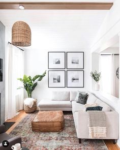 a living room filled with furniture and pictures on the wall above it's coffee table