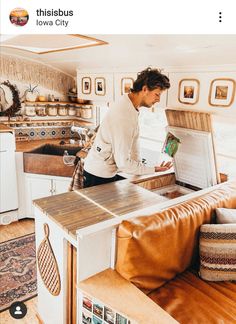 a man standing at the kitchen counter using a laptop