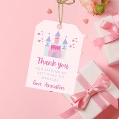 a gift tag with a princess castle on it next to some pink flowers and hearts