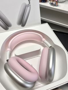 a pair of headphones sitting on top of a white box next to other items