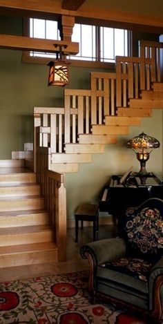 a living room filled with furniture next to a stair case