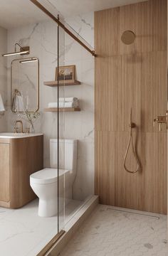 a bathroom with a toilet, sink and shower stall in it's own area