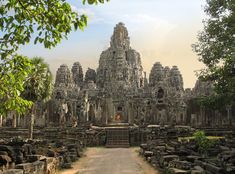 the entrance to an ancient temple surrounded by trees