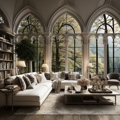 a large living room with arched windows and lots of books on the shelves in it