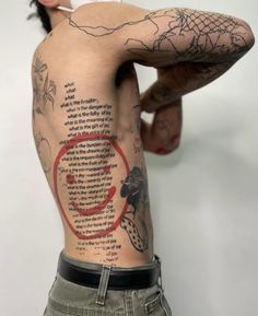 the back of a man with tattoos on his body