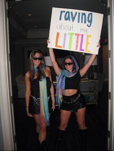 two women holding up a sign that says raviing about my little