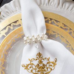 a white and gold plate topped with a napkin