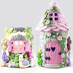 two little houses made to look like they are decorated in pink and green colors, one is