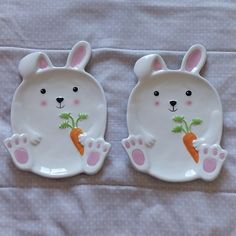 two white plates with bunny ears and carrots on them