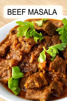 beef masala with cilantro and parsley in a white bowl