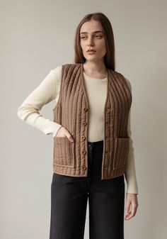 This sale item is final sale. Introducing the all natural quilted outerwear collection. We sourced a beautiful range of linen and cottons to create a versatile vest to layer into all the coldest days ahead. Designed with a mid length straight fit, two front pockets, and tonal corozo nut buttons. 100% Linen Outer100% Cotton fill100% Organic Cotton lining100% Cotton labels/ Corozo nut buttons Dry Clean Only. Made in India by our Fair Trade Certified partners. Model is 5'9" and wears a Small. Need Quilted Cotton Outerwear For Layering, Brown Quilted Cotton Outerwear, Classic Cotton Quilted Jacket For Work, Cotton Vest With Patch Pockets For Fall, Fall Cotton Quilted Vest, Utility Cotton Quilted Jacket With Pockets, Fall Quilted Cotton Vest, Quilted Vest For Layering In Fall, Brown Cotton Vest Outerwear