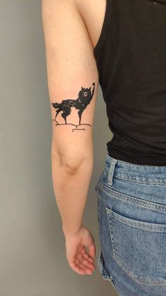 a woman with a tattoo on her arm holding onto the back of her left arm