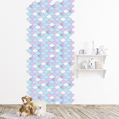 two teddy bears are sitting on a rug in front of a wall with mermaid scales