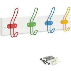 four hooks hang on a white wall next to screws