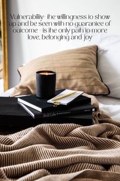 two books and a candle on a bed with a quote from shakespeare about love, belonging and joy