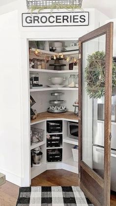 an open pantry in the corner of a room with a black and white checkered rug