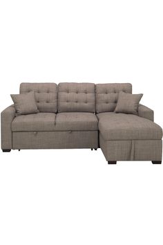 a sectional couch with pillows on it and a footstool attached to the back