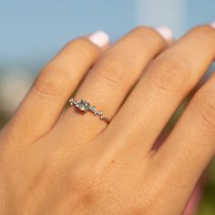 a woman's hand with a diamond ring on it