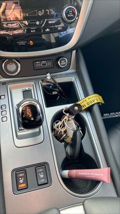 the interior of a car with keys and other items in it's center console