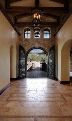 an open entry way with chandelier and stone walls