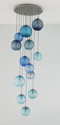 a chandelier with blue glass balls hanging from it