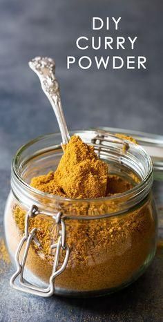 homemade curry powder in a glass jar with a spoon inside and the text overlay reads diy curry powder