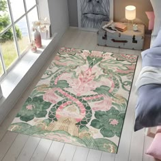 a bedroom with a rug on the floor next to a window and a bed in front of it