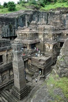 some people are standing in the middle of an ancient building