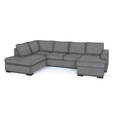 a large gray sectional couch sitting on top of a white floor