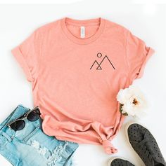 "Minimalist Mountain T-shirt, Aesthetic Shirt, Mountain Line Tee, Hiking Top, Simple Mountain Gift, Camper Shirts, Nature Tee, Aesthetics Tee, Aesthetics T-shirt, Hiking Shirt, Minimalist Mountain, Minimalist Shirt, Simple Mountain Tee, Camping Tee, Hiking Tee, Hiking Top, Minimalist Tee, Minimalist Top, Mountain Shirt, Nature Lover This updated unisex essential fits like a well-loved favorite. Super soft cotton and excellent quality print makes one to fall in love with it over and over again. ------------- Fabrication ------------- 100% Combed ring spun cotton Made by specially treating the cotton fibers before spinning them into yarn. The result is stronger and smoother fabric. ------------- Unisex T-shirt Size Chart ------------- XS - - 27\" Length and 18\" Width S - 28\" Length and 19\ Summer Graphic Tee For Camping, Summer Camping Graphic Tee, Summer Outdoor Screen Print Tops, Summer Camping T-shirt With Crew Neck, Summer Camping Crew Neck T-shirt, Summer Camping Tops With Screen Print, Summer Camping Tops With Relaxed Fit, Relaxed Fit Summer Tops For Camping, Summer Camping Shirt With Crew Neck