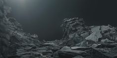 an image of rocks in the dark with light coming from behind them on a black and white background