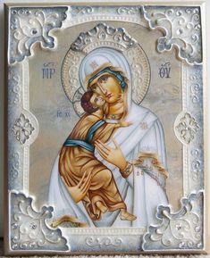 an icon of the mother and child in white with gold trimmings on it