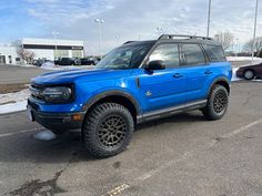 a blue suv parked in a parking lot