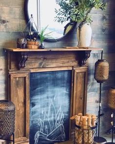 a fireplace with a chalkboard on the mantle and potted plants next to it